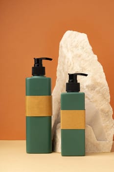 Dark green plastic bottles for skincare cosmetics on yellow background
