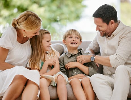 Family, tickle and play on sofa, laughing and bonding at home, fun and silly humor or comedy. Parents and children, connection and security in relationship, happy and care on couch, love and goofy