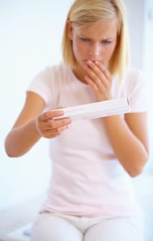 Anxiety, nervous and woman with pregnancy test in bathroom waiting for results, news and lines. Motherhood, pregnant and worried person with medical testing kit for fertility or ovulation at home.