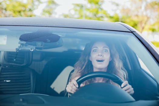 a beautiful woman motorist driving with emotions