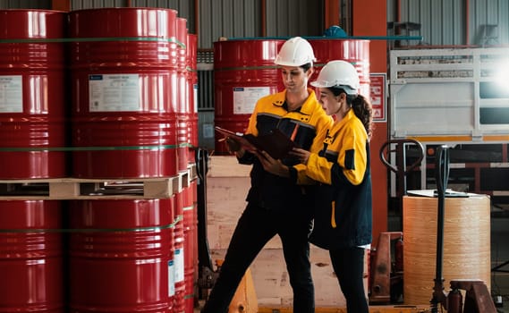 Two inventory inspector conduct inspection on chemical barrel. Exemplifying