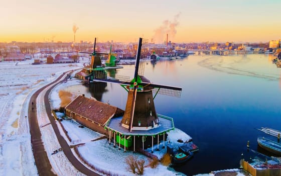snow covered windmill village in the Zaanse Schans Netherlands, historical wooden windmills in winter Zaanse Schans Holland