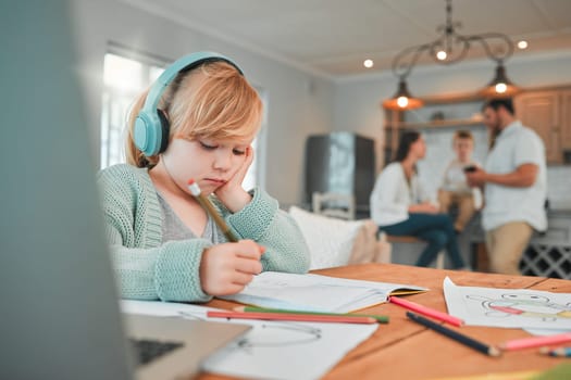 Girl, writing and book with headphones for elearning, study or homework in living room or table at home. Young female person, kid or child taking notes or homeschool with headset for online learning