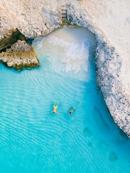 couple man and woman in a crystal clear ocean in the Caribbean Aruba Island Tres Trabi Beach
