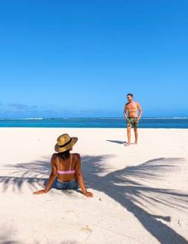 Man and Woman on a tropical beach in Mauritius, a couple on honeymoon vacation in Mauritius