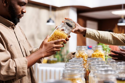 Man checking out the pasta in jars