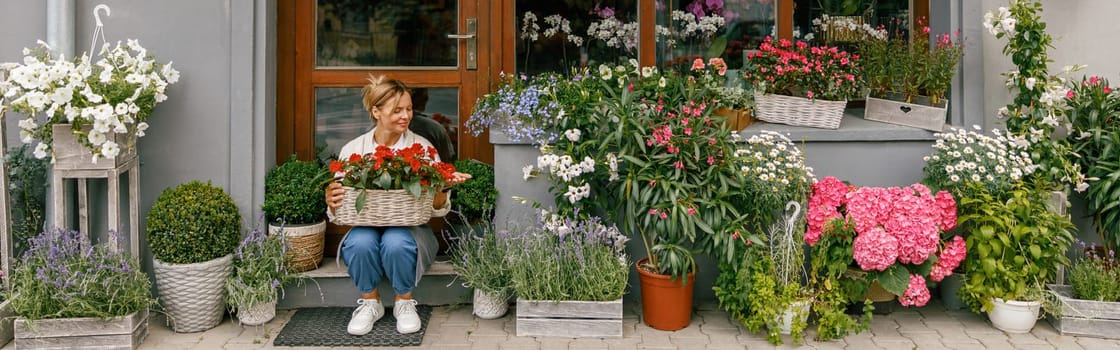 Professional woman florist business owner sitting with houseplants on background of floral store