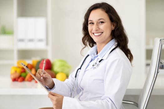 Portrait of smiling brunette woman working at clinic