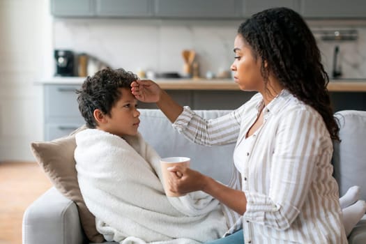 Caring Black Mother Taking Care About Her Ill Son At Home