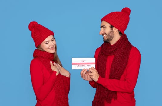 Happy Young Woman Getting Gift Certificate From Her Loving Boyfriend
