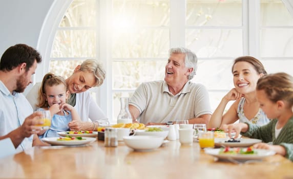 Dinner, children and happy in big family home with eating, talk and laugh with mom, dad and grandparents. Men, women and kid for food, lunch or brunch for memory, conversation or smile in dining room