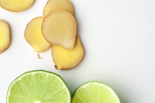 Lime and ginger slices on white background