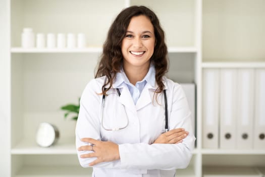 Portrait of friendly smiling millennial woman doctor