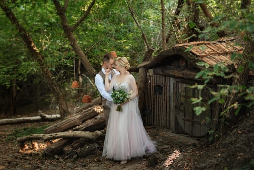 wedding walk of the bride and groom in a coniferous in elven accessories