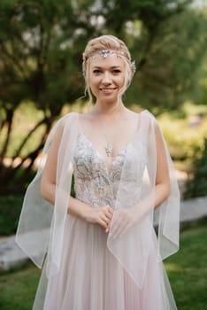 portrait of a happy bride in a light light dress in  wearing elven accessories