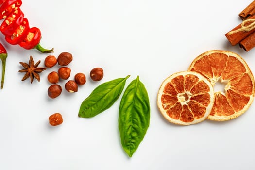 Dried oranges and spices isolated on white background