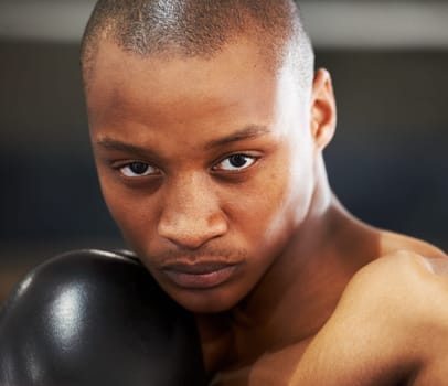 Boxing, gloves and portrait of fearless black man training with fitness, power and workout challenge. Strong body, muscle and boxer in gym, athlete with fist up and confidence in competition fighting