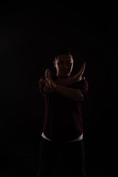 A man dancing in the dark in a studio
