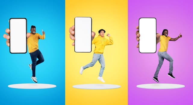 Happy millennial asian, black men show phone with empty screen, thumb up sign, jump at platform