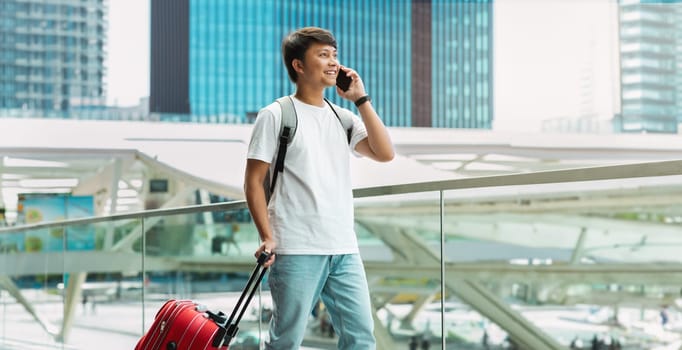 Handsome Young Asian Man Talking On Cellphone In Airport
