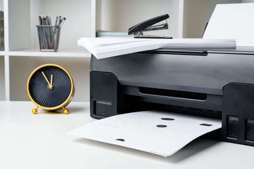 Workplace with modern printer and clock in the office
