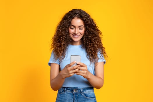 Content young woman texting on smartphone