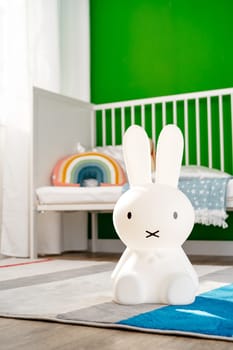 Toy rabbit lamp in nursery room close up.