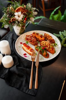 Eclairs on a marble plate on a background with Christmas or New Year decor. High quality photo