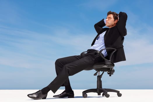 Business man, relax and outdoor nap of a corporate professional in a chair with peace from success. Worker, calm and young male employee and suit with mockup space and blue sky with job and career