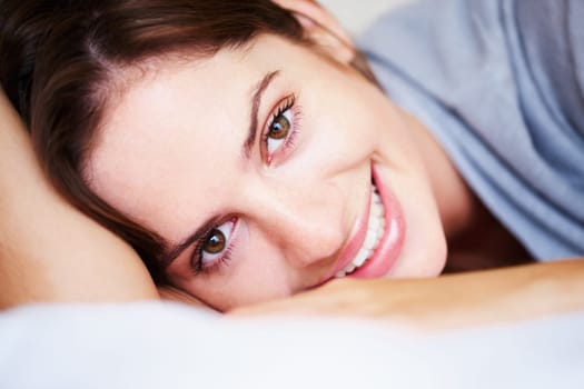 Relax, smile and portrait of woman on bed for sleeping, dreaming and comfortable at home. Happy, cozy and face of person in bedroom resting, nap and wake up for health, wellness and calm in morning