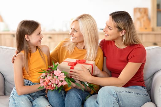 Family celebrating Mother's Day with gifts at home
