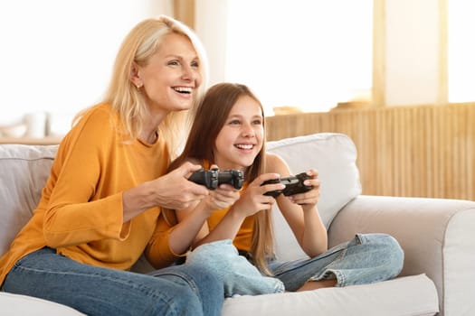 Happy teen girl having fun with her grandmother at home