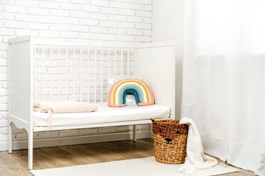 Kid's room interior with comfortable bed and rainbow pillow