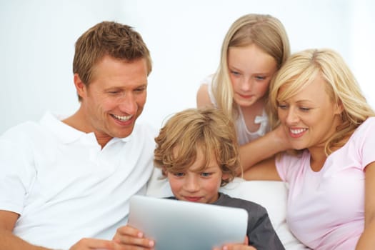 Mother, father and kids smile with tablet for elearning, video games or reading ebook story on app at family home. Mom, dad and children watching cartoon, streaming digital multimedia or subscription