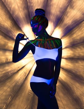 Seductive slender girl dancing in neon light
