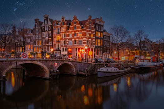 Amsterdam Netherlands canals with lights during evening in December during winter in the Netherlands