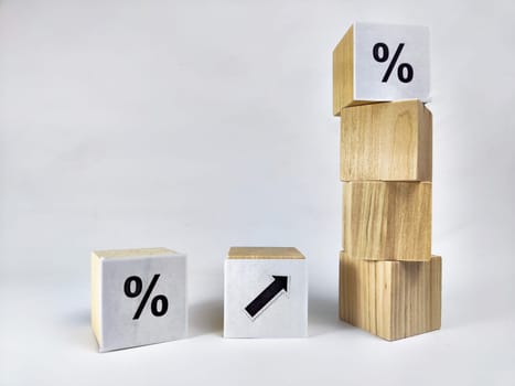 Wooden cubes with arrows and percentages on a black background. Stages of action and goal achievement. Planning. Business actions. Receiving income and profit