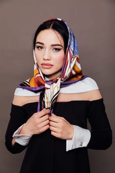 Portrait of a beautiful brunette woman in a headscarf