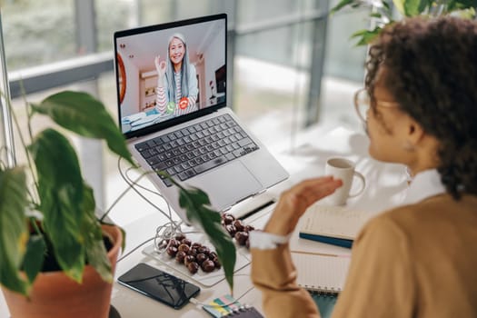 Female freelancer have video conference with client while sitting in cozy coworking