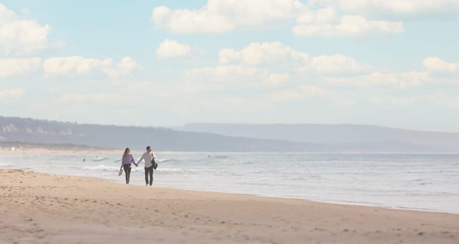 25 november 2023, Lisbon, Portugal - Love couple Walking on a Beach Near the Ocean