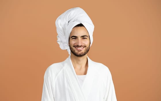 Smiling Hispanic Guy With Towel Wrapped On Head, Brown Background