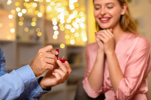 Excited woman getting a proposal with ring