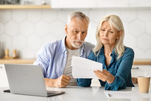 Upset Elderly Spouses Checking Financial Documents While Calculating Family Budget At Home
