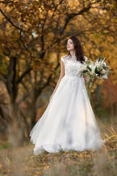 beautiful happy bride holding wedding autumn bouquet