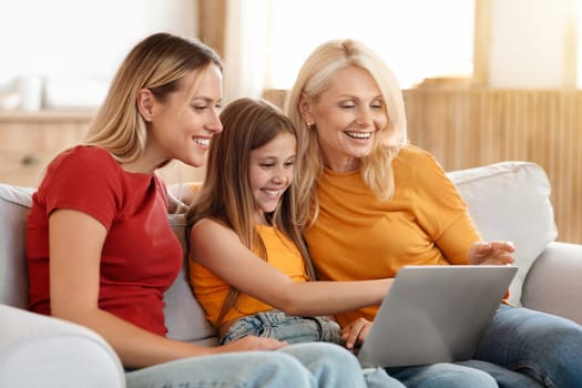 Three generations women family using laptop at home