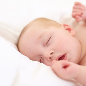 Baby, sleeping and bed in home, closeup and nursery with growth, development and wellness in room. Infant, child and newborn with rest, tired or dream in bedroom for health in family house with peace.