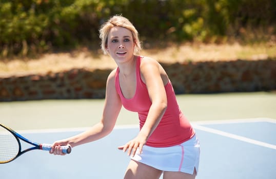 Tennis, sport or woman with racket on court for competition, match or training outdoor with happiness. Player, person or game with exercise, workout or competitive with wellness or fitness in summer