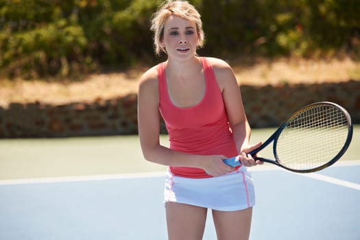Tennis, sport or woman with racket on court for competition, match or training outdoor with concentration. Player, person or game with exercise, workout or competitive with wellness and fitness