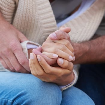 Couple, holding hands and closeup with love, care and support with empathy for illness, diagnosis or cancer. Solidarity, man and woman with gratitude, respect or comfort partner in crisis of health