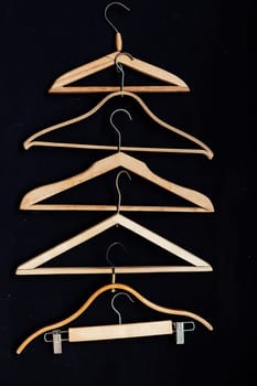 old wooden hangers for fashionable things on the background